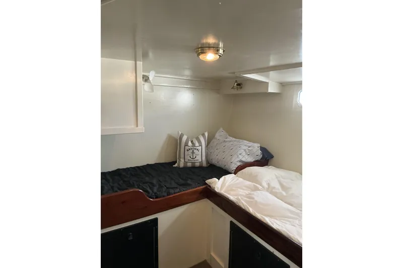 Slide: The Image of Cozy cabin interior of 2009 Hugh Huff Custom Pilothouse Trawler with nautical-themed pillows. - 43