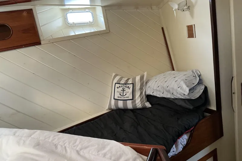 Slide: The Image of Cozy cabin bed in 2009 Hugh Huff Custom Pilothouse Trawler with nautical decor. - 44
