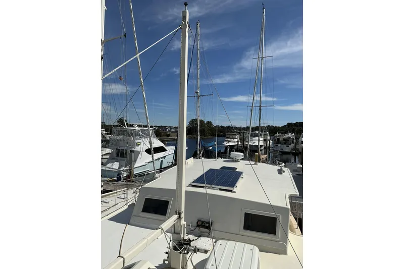 Slide: The Image of 2009 Hugh Huff Custom Pilothouse Trawler with solar panel, docked at marina. - 8