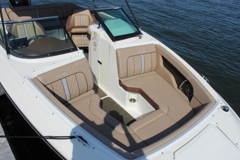 Slide: The Image of 2016 Sea Ray SunDeck 220 boat with beige seating, docked on calm water. - 17