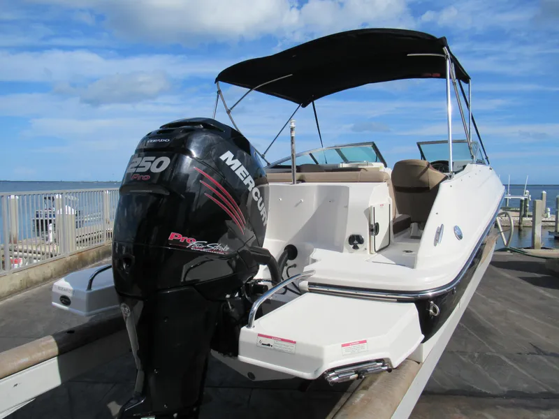 Slide: The Image of 2016 Sea Ray SunDeck 220 boat with Mercury 250 Pro engine, docked by the sea. - 3