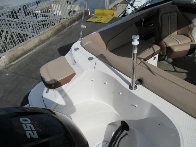 Slide: The Image of 2016 Sea Ray SunDeck 220 boat interior with seating and motor. - 6