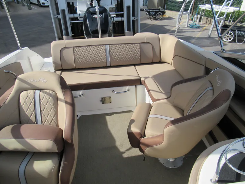 Slide: The Image of 2016 Sea Ray SunDeck 220 interior with beige and brown seating. - 9