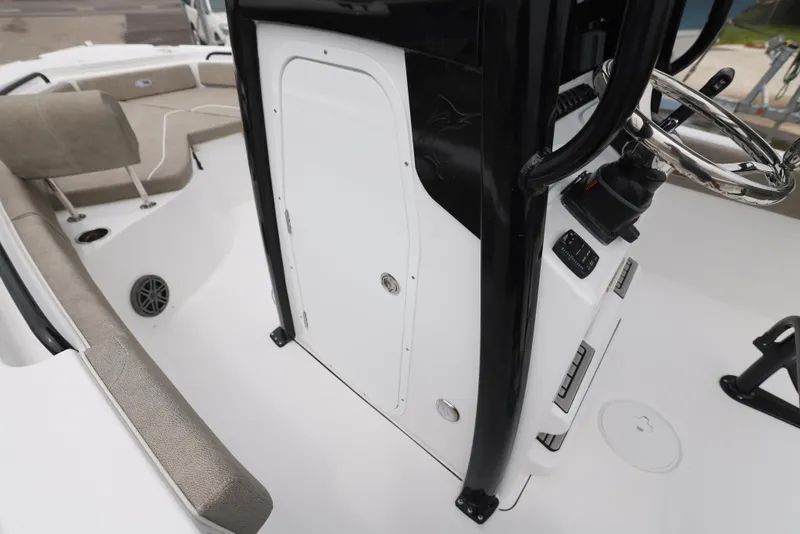 Slide: The Image of 2026 Sea Hunt Ultra 235 SE boat interior with steering console and seating area. - 12