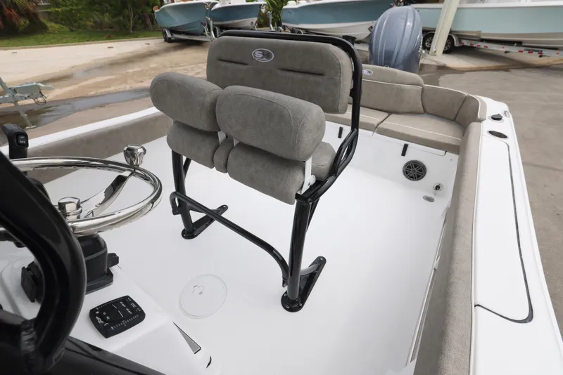 Slide: The Image of 2026 Sea Hunt Ultra 235 SE boat interior with cushioned seating and steering wheel. - 13