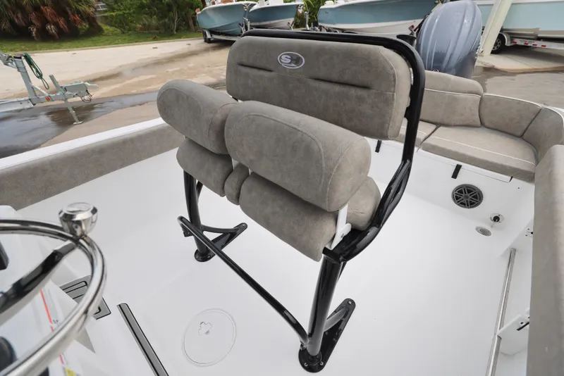 Slide: The Image of 2026 Sea Hunt Ultra 235 SE boat interior with cushioned seating and steering wheel. - 16
