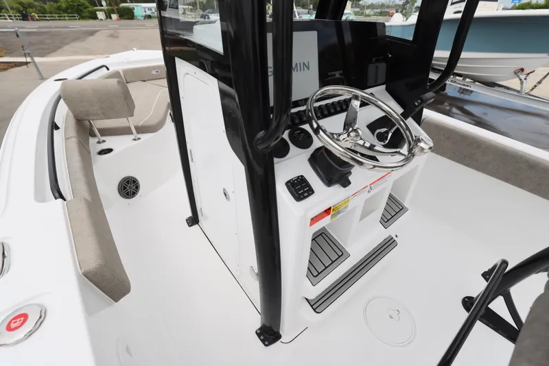 Slide: The Image of 2026 Sea Hunt Ultra 235 SE boat cockpit with steering wheel and seating. - 4