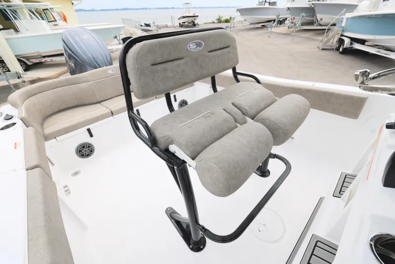 Slide: The Image of 2026 Sea Hunt Ultra 235 SE boat interior with cushioned seating and steering area. - 6