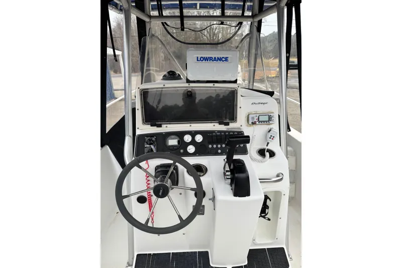 Slide: The Image of 1999 Boston Whaler 21 Outrage boat console with steering wheel and navigation equipment. - 4