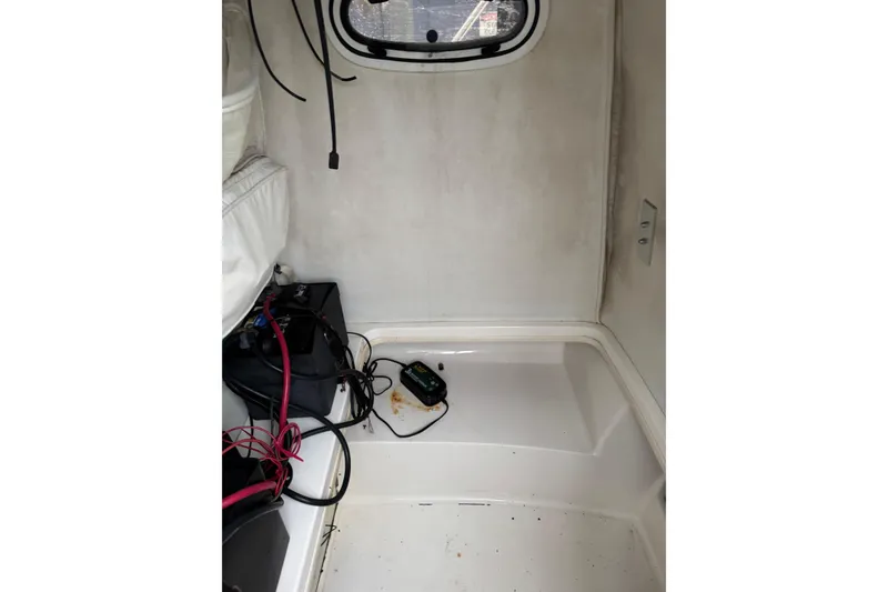 Slide: The Image of Interior of a 1999 Boston Whaler 21 Outrage boat, showing wiring and equipment. - 7