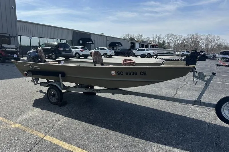 Slide: The Image of 2012 G3 1544 LW boat on trailer in parking lot, sunny day. - 3