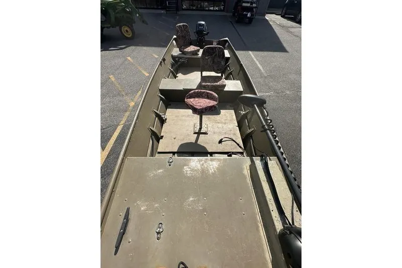 Slide: The Image of 2012 G3 1544 LW boat with camouflage seats and motor, parked outdoors. - 4