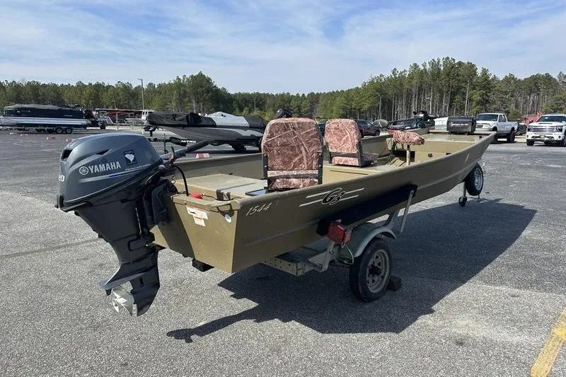Slide: The Image of 2012 G3 1544 LW boat with Yamaha motor on trailer in parking lot. - 5