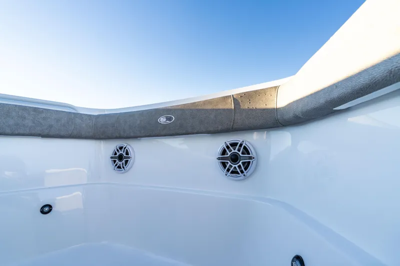 Slide: The Image of 2026 Sea Hunt Ultra 275 Coffin Box boat interior with speakers and cushioned seating. - 34