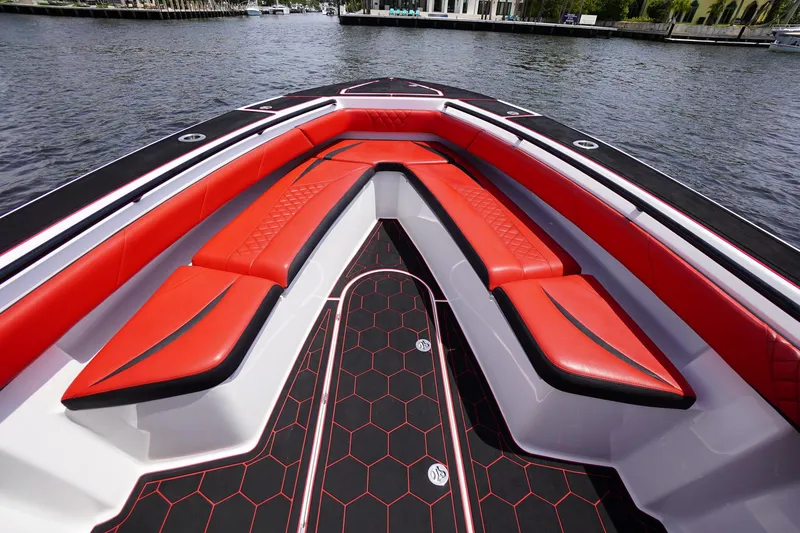 Slide: The Image of 2020 Statement 380 Open boat with red seating on water. - 14