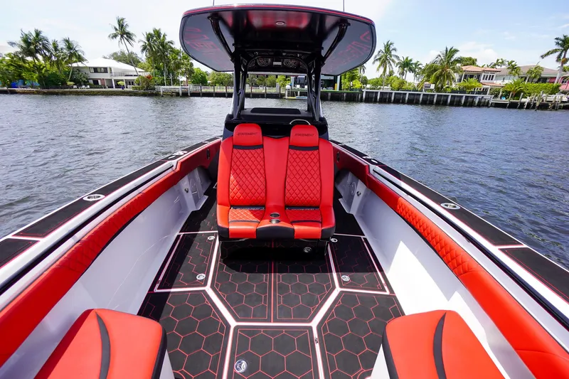 Slide: The Image of Luxurious 2020 Statement 380 Open boat with red seating on the water. - 15