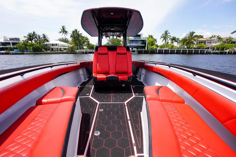 Slide: The Image of 2020 Statement 380 Open boat with red seating on water. - 16