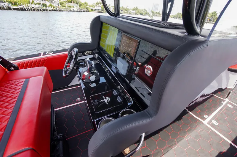 Slide: The Image of Interior of 2020 Statement 380 Open with red seating and control console. - 23