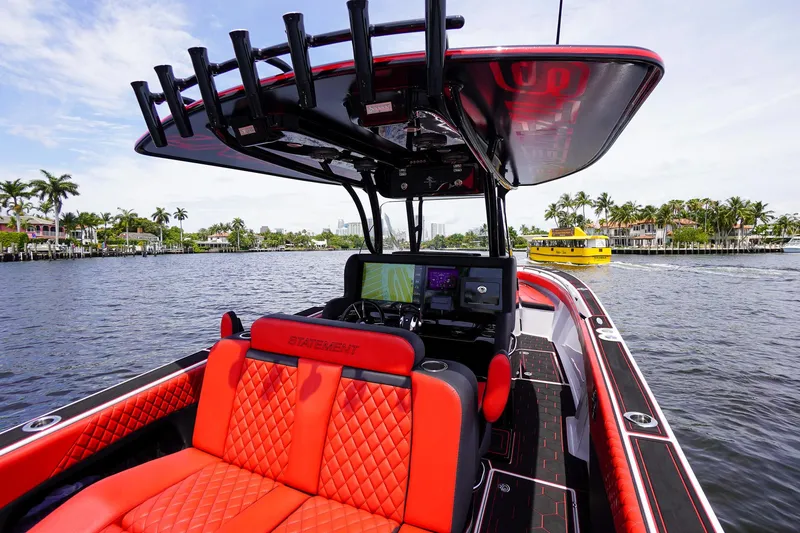 Slide: The Image of Luxurious 2020 Statement 380 Open boat with red seats on the water. - 30