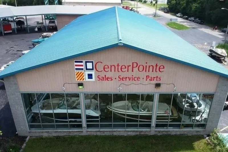 Slide: The Image of CenterPointe building with boats, blue roof, and glass front. - 9