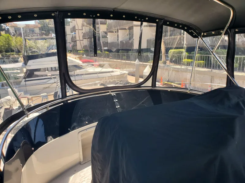 Slide: The Image of Interior view of a 1991 Wellcraft 3300 Sport Bridge boat at a marina. - 11