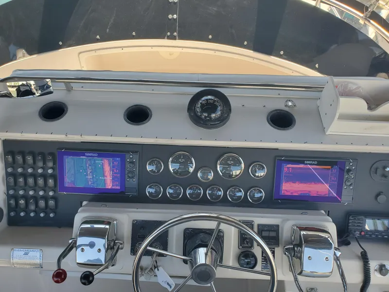 Slide: The Image of 1991 Wellcraft 3300 Sport Bridge dashboard with navigation screens and controls. - 14