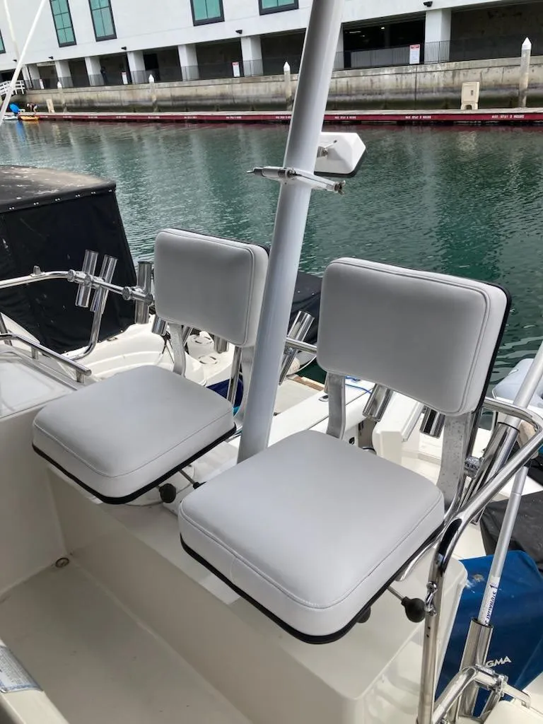 Slide: The Image of 1991 Wellcraft 3300 Sport Bridge boat seats by the water. - 20