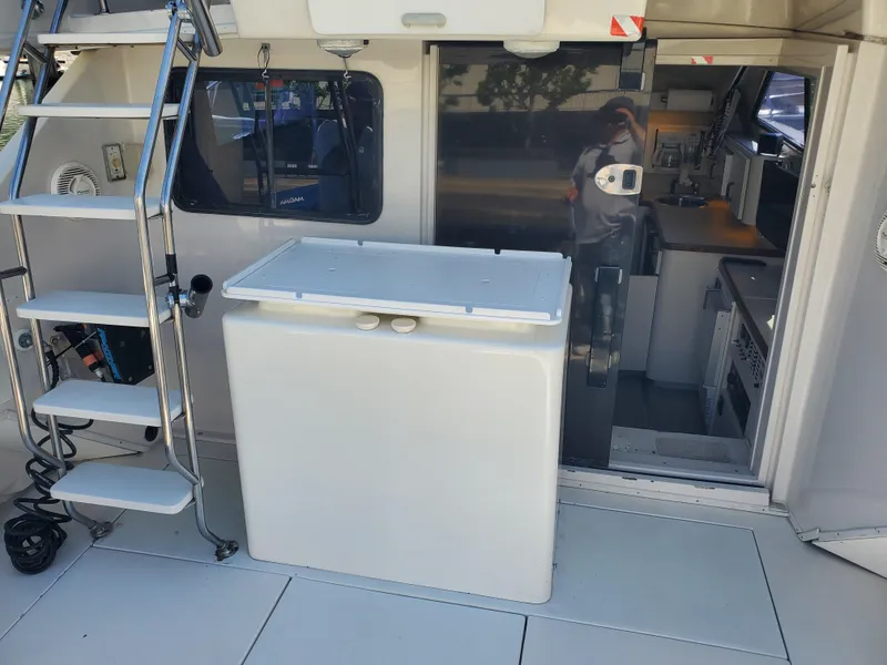 Slide: The Image of 1991 Wellcraft 3300 Sport Bridge interior with stairs and kitchenette. - 21