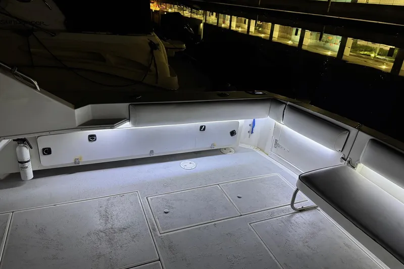 Slide: The Image of 1991 Wellcraft boat deck with seating, illuminated by LED lights at night. - 28