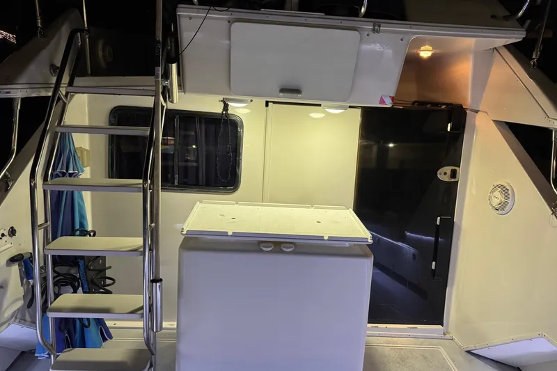 Slide: The Image of 1991 Wellcraft boat interior with stairs, storage, and lighting. - 29