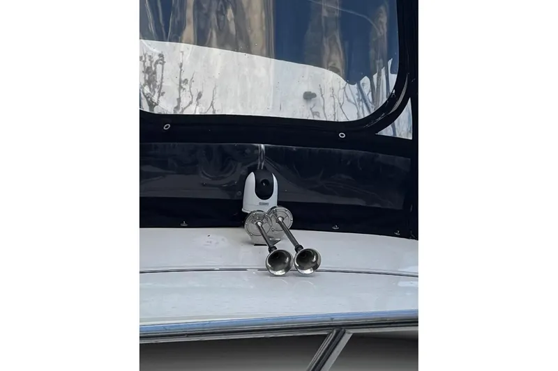 Slide: The Image of 1991 Wellcraft boat with dual horns and a mounted camera on the deck. - 30