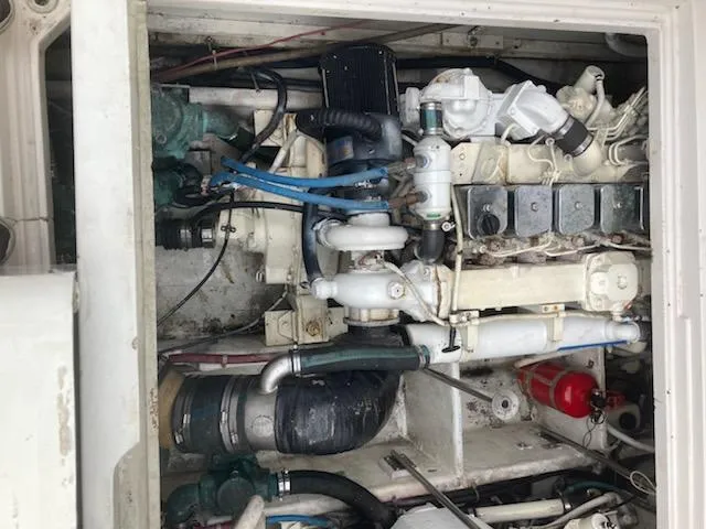 Slide: The Image of Engine compartment of a 1991 Wellcraft 3300 Sport Bridge boat, showcasing mechanical components. - 36