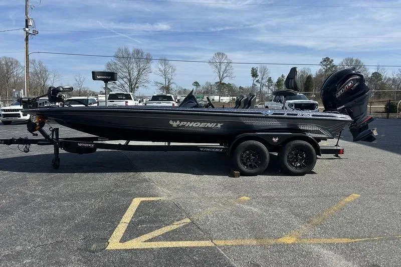 The Image of 2026 Phoenix 921 Elite X boat on trailer in parking lot, side view. - 1