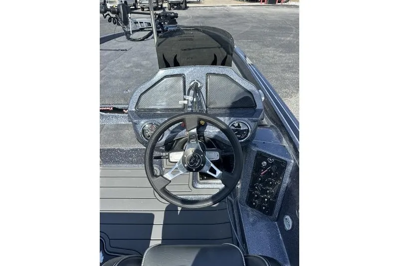 Slide: The Image of 2026 Phoenix 921 Elite X boat dashboard with steering wheel and control panel. - 11