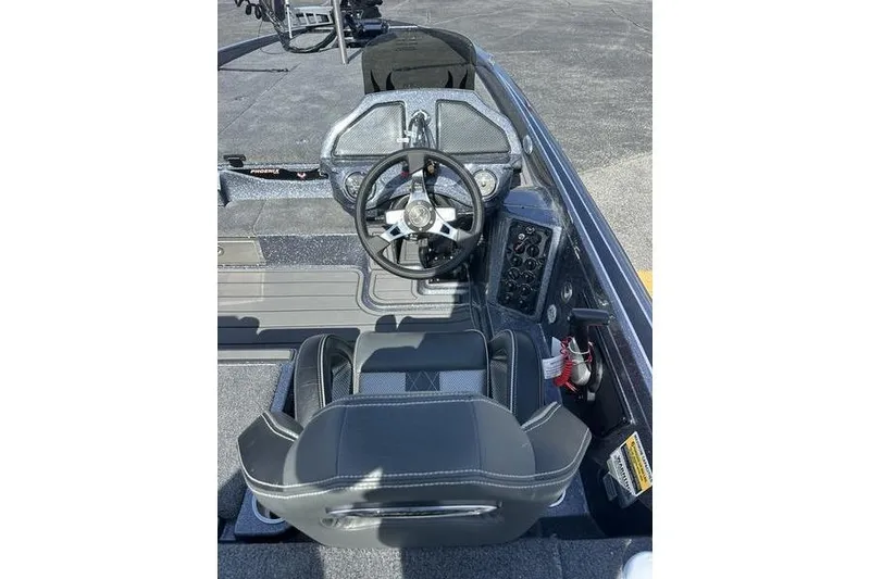 Slide: The Image of 2026 Phoenix 921 Elite X boat cockpit with steering wheel and control panel. - 12