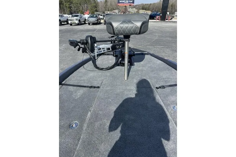 Slide: The Image of 2026 Phoenix 921 Elite X boat deck with seat and equipment, parked outdoors. - 13