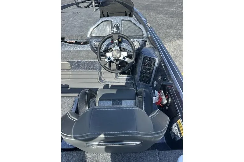 Slide: The Image of 2026 Phoenix 921 Elite X boat cockpit with steering wheel and control panel. - 15