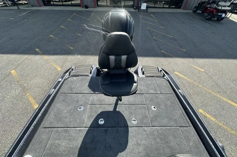 Slide: The Image of 2026 Phoenix 921 Elite X boat with a sleek black seat on a spacious deck. - 9