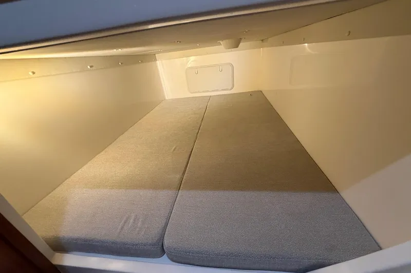 Slide: The Image of 2026 NorthCoast 255 Cabin interior with cushioned sleeping area, well-lit and spacious. - 12