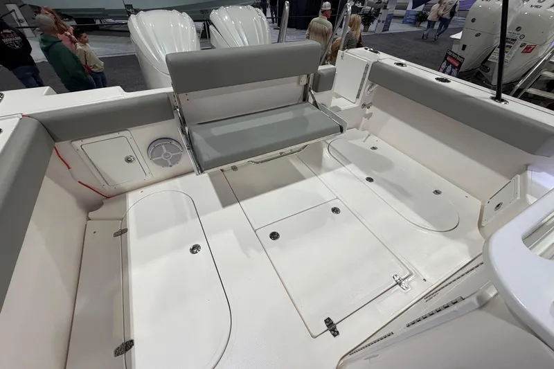 Slide: The Image of 2026 NorthCoast 255 Cabin boat interior with foldable seating and storage compartments. - 3