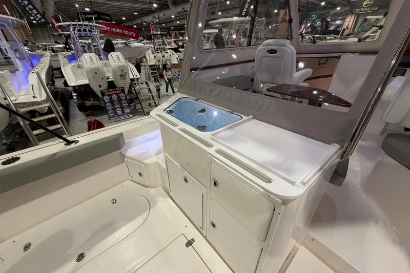 Slide: The Image of 2026 NorthCoast 255 Cabin interior at a boat show, showcasing seating and storage features. - 5