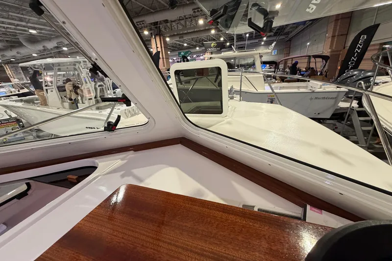 Slide: The Image of Interior view of 2026 NorthCoast 255 Cabin at a boat show. - 8