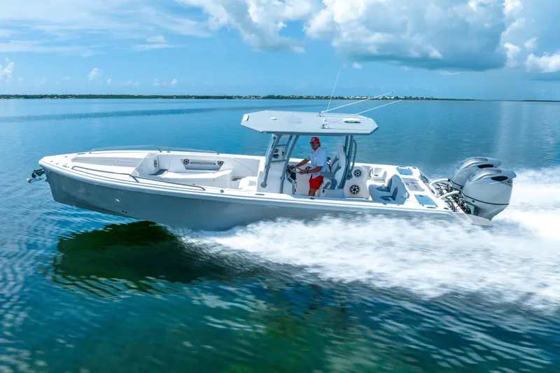The Image of 2023 Dynamic D-305V boat cruising on clear blue water under a sunny sky. - 0
