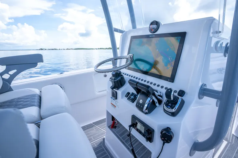 Slide: The Image of Modern boat dashboard with navigation screen, steering wheel, and controls on a Dynamic D-305V, 2023 model. - 11