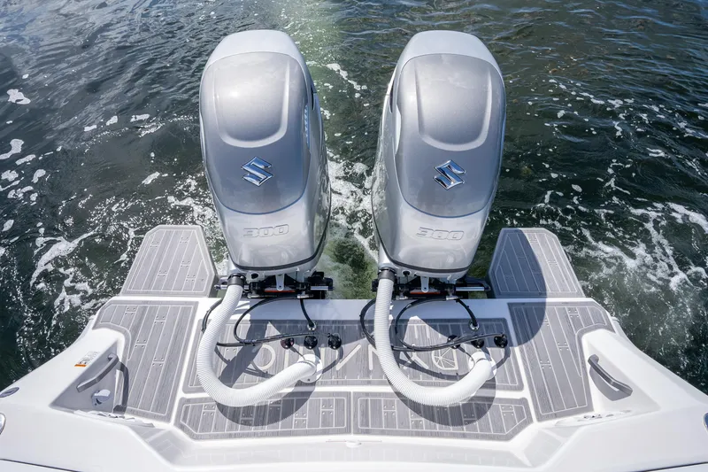 Slide: The Image of Twin outboard motors on a Dynamic D-305V boat, 2023 model, in water. - 14