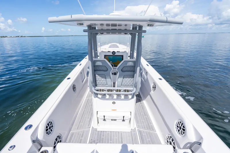 Slide: The Image of 2023 Dynamic D-305V boat on calm water, featuring sleek design and modern controls. - 15