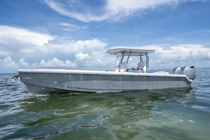 Slide: The Image of 2023 Dynamic D-305V boat on calm water under a clear blue sky. - 16