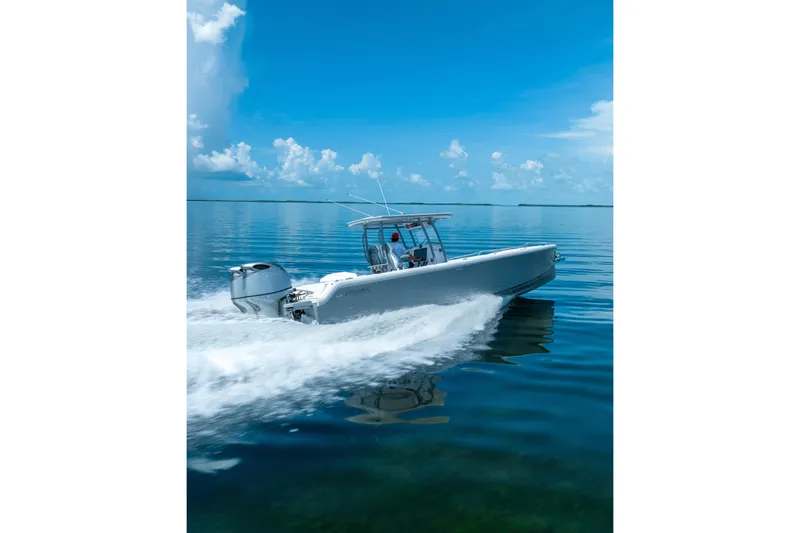 Slide: The Image of Dynamic D-305V 2023 boat cruising on calm blue waters under a clear sky. - 3