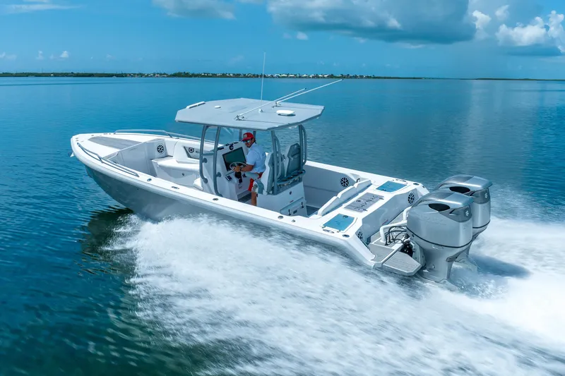 Slide: The Image of 2023 Dynamic D-305V boat cruising on clear blue water under a sunny sky. - 4