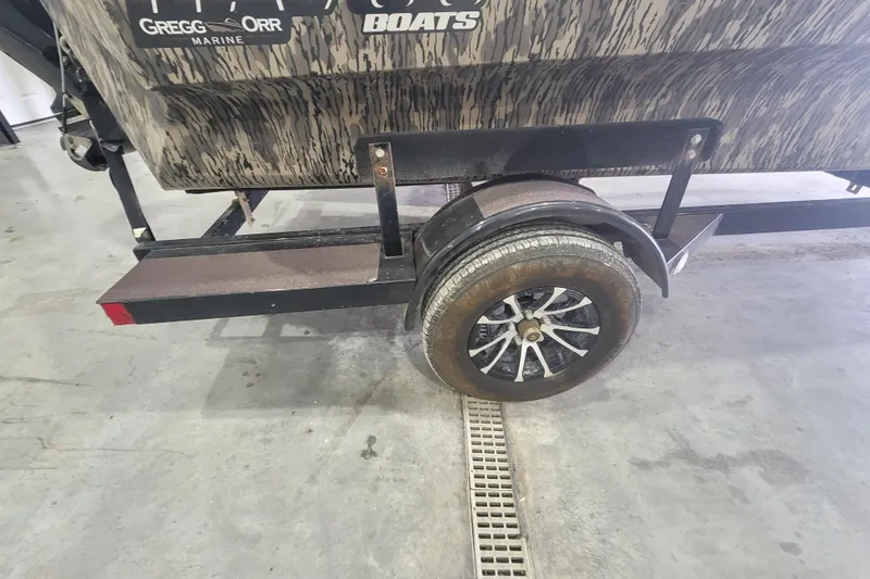 Slide: The Image of Trailer wheel of 2023 Havac FRRSC boat on concrete floor. - 14